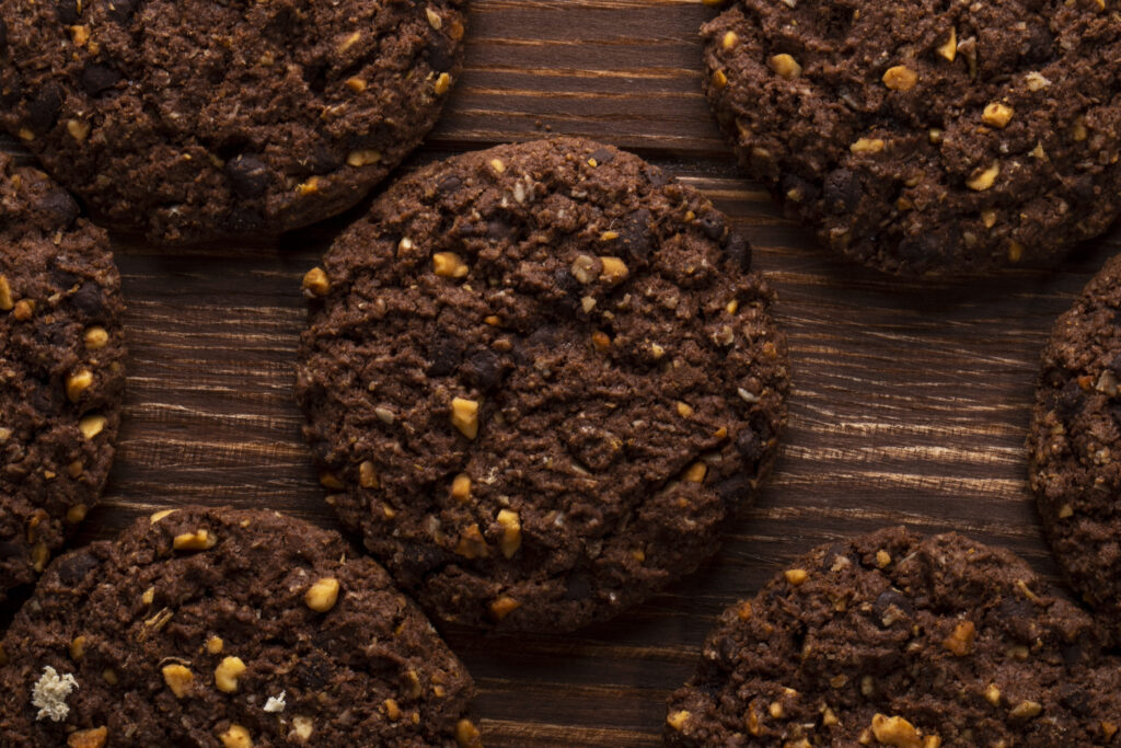 top view chocolate chip cookies with cereals nuts cocoa wooden