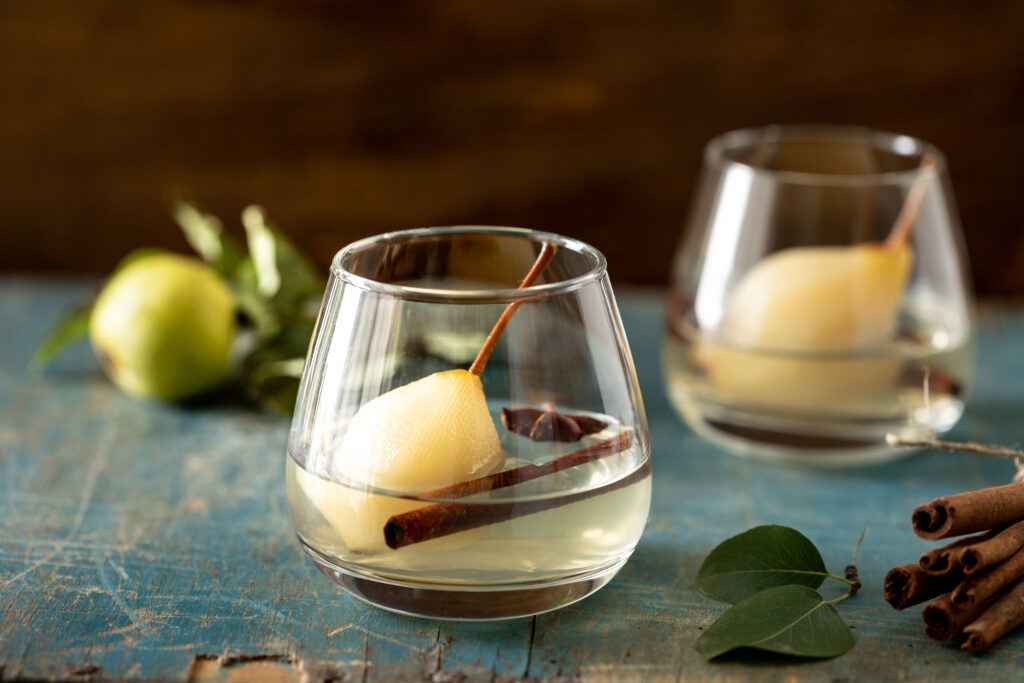 two glasses with drink with sweet pears stewed white wine wooden table delicious drink holiday